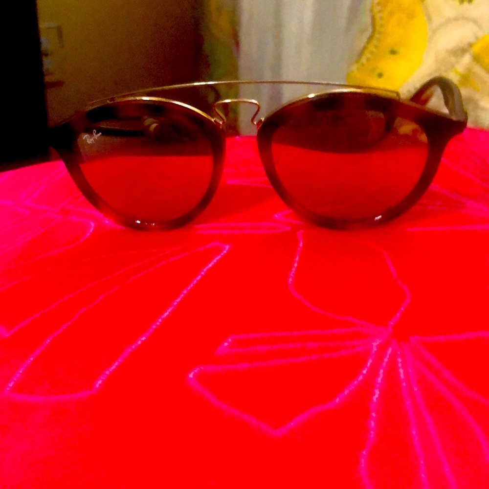 Ray Ban sunglasses 😎 really cool. They are a tortoise color with a gold trim.